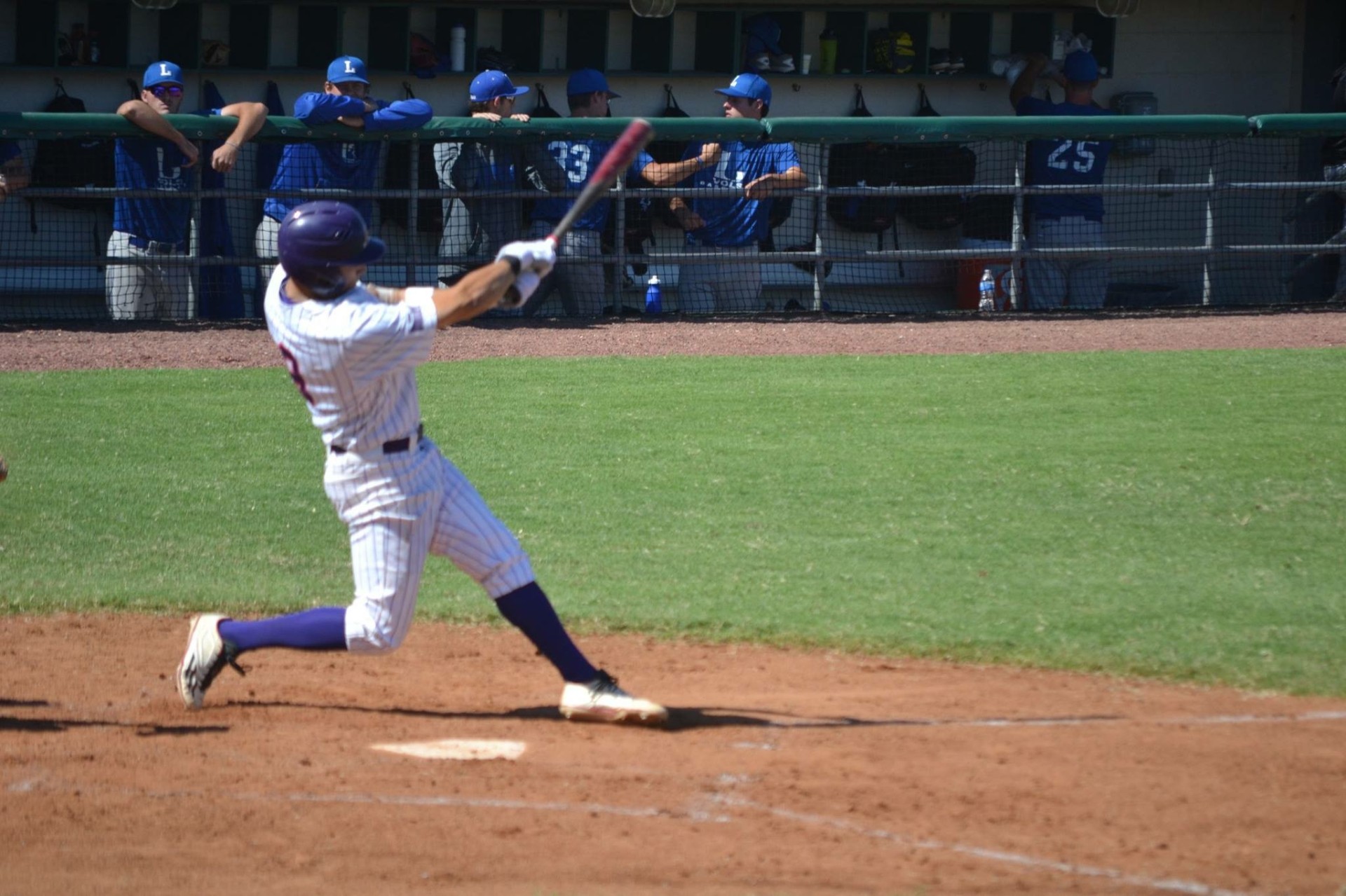 Baseball game action — hitter making contact